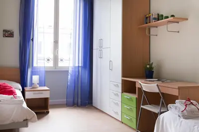 a bedroom with a desk and a bed and a window at Beautiful apartment in San Giovanni close to Colosseo in Rome