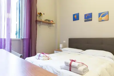 a bedroom with a bed with towels on it at Beautiful apartment in San Giovanni close to Colosseo in Rome