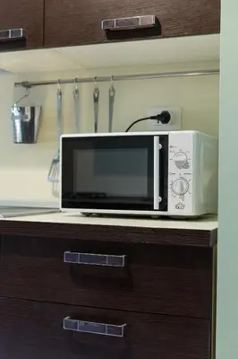 a microwave sitting on a counter in a kitchen at Beautiful apartment in San Giovanni close to Colosseo in Rome