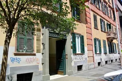 a building with green doors and graffiti on it at Beautiful apartment in San Giovanni close to Colosseo in Rome