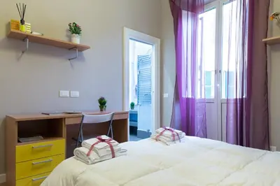 a bedroom with a bed and a desk and a window at Beautiful apartment in San Giovanni close to Colosseo in Rome