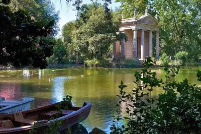 a small boat in the water in front of a building at La Casa del Fotografo in Rome