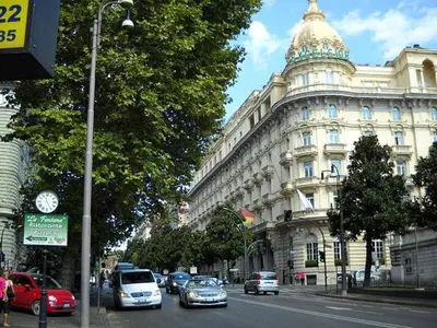 a busy city street with cars parked in front of a building at La Casa del Fotografo in Rome