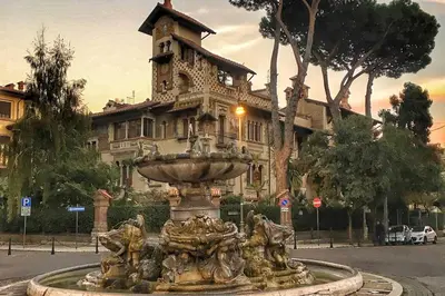 a fountain in front of a large building at La Casa del Fotografo in Rome