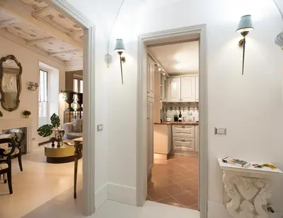 a kitchen with a door leading into a living room at Roma Fontana di Trevi in Rome