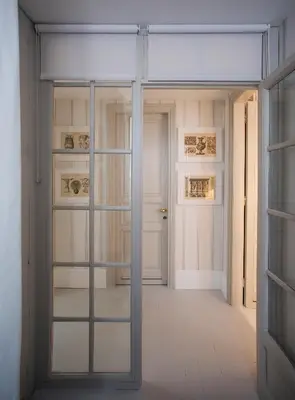 a room with glass doors and a room with paintings at Roma Fontana di Trevi in Rome
