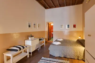a bedroom with a bed and a desk in a room at ROMAC Baullari Holiday Apartment in Campo de Fiori in Rome