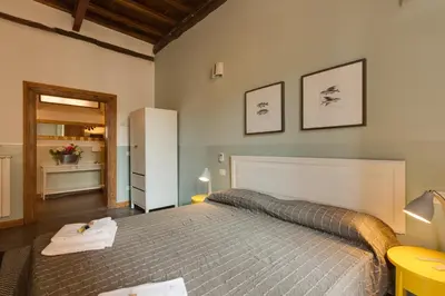 a bedroom with a large bed in a room at ROMAC Baullari Holiday Apartment in Campo de Fiori in Rome