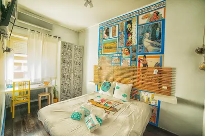a bedroom with a bed with pictures on the wall at Fly B&B in Rome