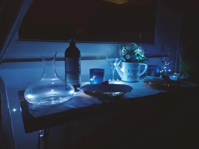 a table with a bottle of wine and glasses on it at Fly B&B in Rome