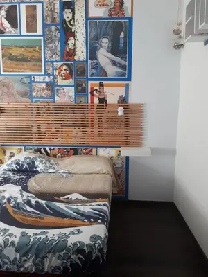 a bedroom with a wall covered in pictures at Fly B&B in Rome