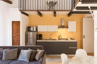 two beds in a room with white walls at Experience Collection by ROMAC - Margana Palace in Rome