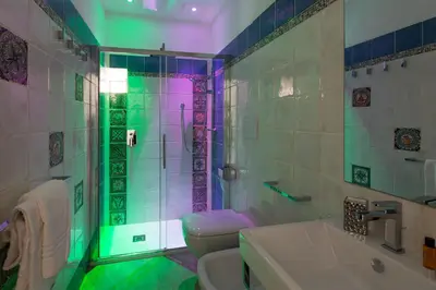 a bathroom with a shower and a toilet and a sink at Experience Collection by ROMAC - Margana Palace in Rome