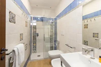 a bathroom with a toilet and a sink and a shower at Experience Collection by ROMAC - Margana Palace in Rome