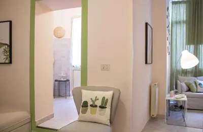 a living room with a chair with a pillow on it at Apartment Rome & More in Rome