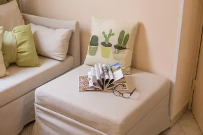 a table with a book and glasses on a couch at Apartment Rome & More in Rome