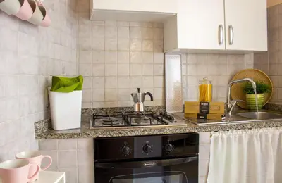 a kitchen with a stove and a sink at Apartment Rome & More in Rome