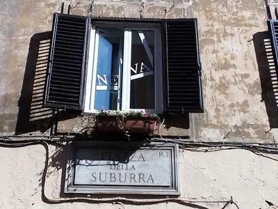 a window on a building with a sign on it at Apartment Rome & More in Rome