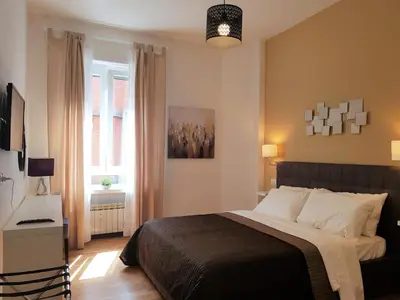 a bedroom with a bed and a window at Sonny Capone Al Vaticano in Rome
