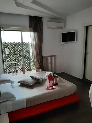 a bedroom with a large bed with a television on the wall at Caos Calmo in Rome