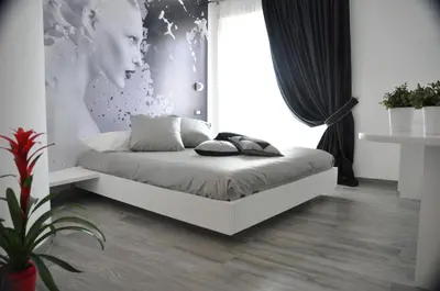 a bedroom with a bed with a large window at Caos Calmo in Rome