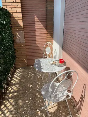 a patio with a table and two chairs on a patio at Caos Calmo in Rome