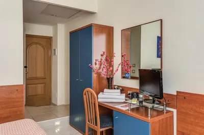 a room with a desk with a computer and a mirror at Hotel Katty in Rome