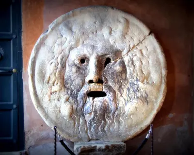 a relief of a face on a wall at Colosseo Rooms Imperial Rome in Rome
