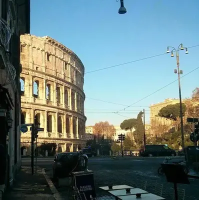a large building sitting on the side of a street at Colosseo Rooms Imperial Rome in Rome