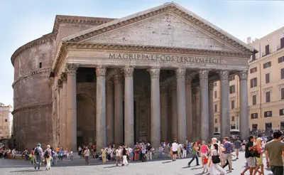 a group of people walking in front of a building at Colosseo Rooms Imperial Rome in Rome