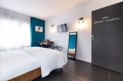 a bedroom with a bed and a door with a mirror at co.sleep in Rome
