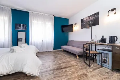 a bedroom with a bed and a desk and a couch at co.sleep in Rome