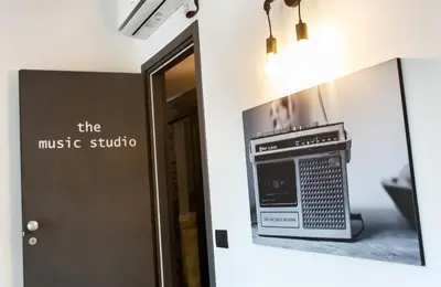a sign that says the music studio next to a door at co.sleep in Rome