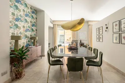 a dining room with a glass table and chairs at ROMAC Fontanella Borghese Palace in Rome