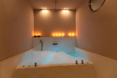 a bathroom with a bath tub with lights in it at ROMAC Fontanella Borghese Palace in Rome