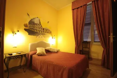 a bedroom with a bed and a picture of the eiffel tower at Hotel Termini in Rome