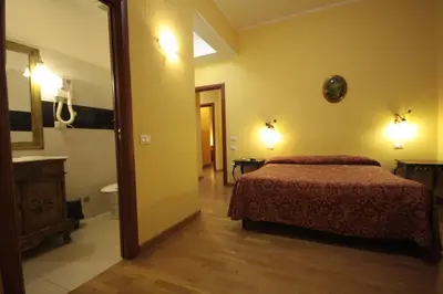 a bedroom with a bed and a bathroom at Hotel Termini in Rome