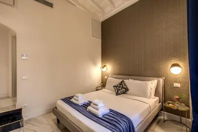 a bedroom with a bed with towels on it at Little Queen Pantheon in Rome