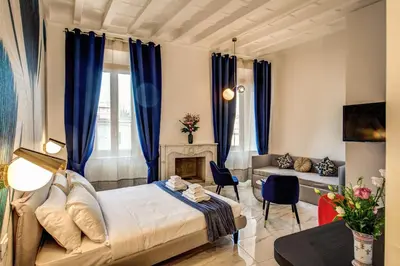 a bedroom with a bed and a fireplace at Little Queen Pantheon in Rome