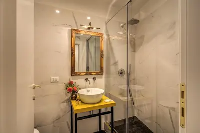 a bathroom with a sink and a shower at Little Queen Pantheon in Rome