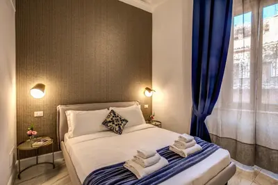 a bedroom with a bed with towels on it at Little Queen Pantheon in Rome