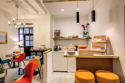 a kitchen with orange chairs and a counter at Little Queen Pantheon in Rome