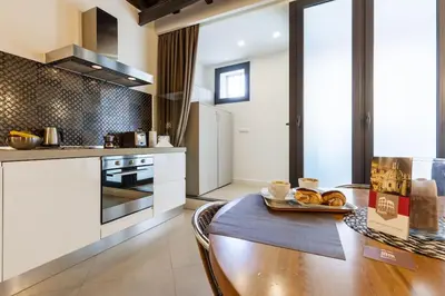 a kitchen with a wooden table with a plate of food at Maison Romana Loft in Rome
