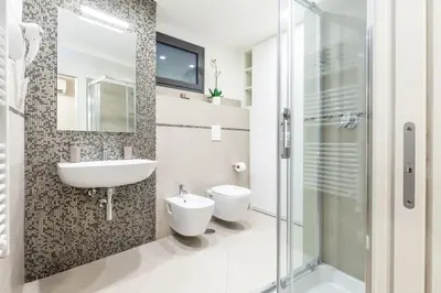 a bathroom with a sink and a toilet and a shower at Maison Romana Loft in Rome