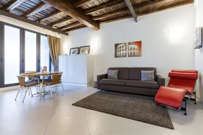 a living room with a couch and a table at Maison Romana Loft in Rome