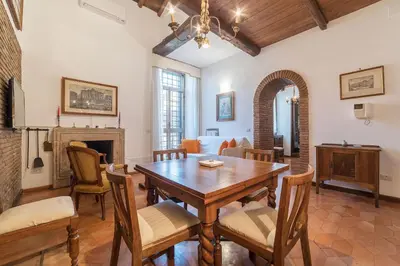 a dining room with a wooden table and chairs at Trevi's Roof Terraces in Rome