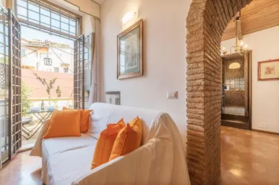 a living room with a white couch with orange pillows at Trevi's Roof Terraces in Rome