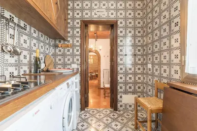 a kitchen with black and white tiles on the wall at Trevi's Roof Terraces in Rome