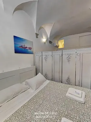 a bedroom with a large bed with a white bed frame at NAVONA & CASTEL SANT'ANGELO WHOLE HOLIDAY APARTMENT da PAMINO & PRISCILLA in Rome