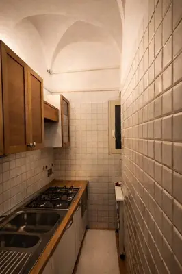 a small kitchen with a sink and a stove at NAVONA & CASTEL SANT'ANGELO WHOLE HOLIDAY APARTMENT da PAMINO & PRISCILLA in Rome